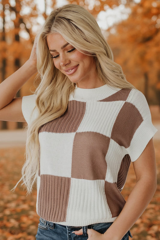 Woman wearing a checkered sweater in an autumn setting